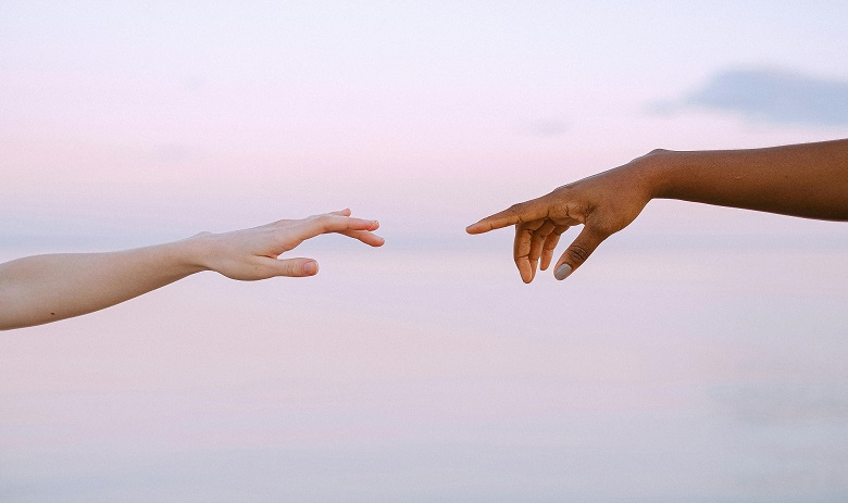 Deux mains qui se touchent presque d'un doigt